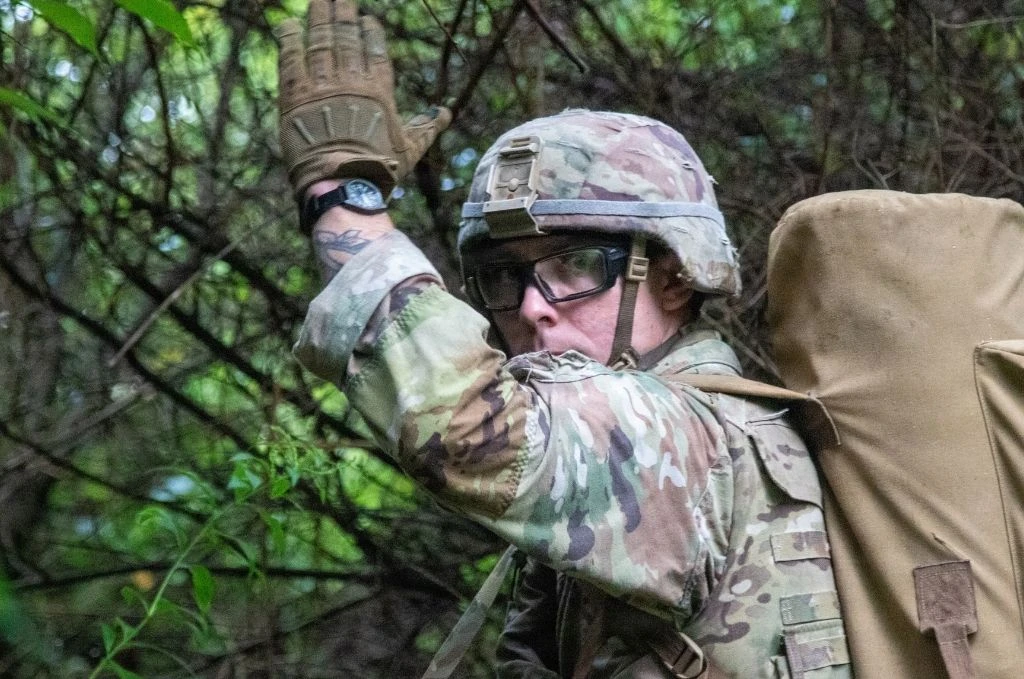 A soldier holdingg up his hand