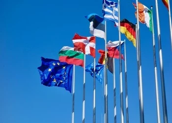 Flags of European nations and EU against blue sky