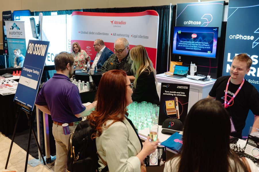 Expo floor &mdash; branded sponsor stands including Capgemini and SideTrade