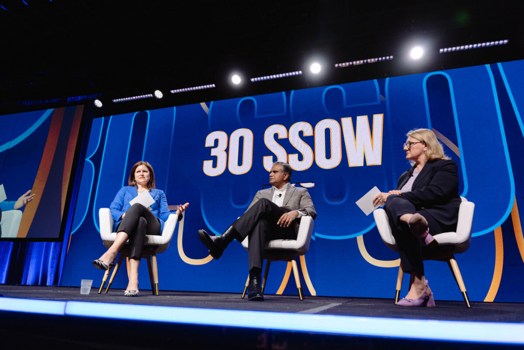 Main stage panel discussion &mdash; three speakers on stage in front of 30 SSOW branding