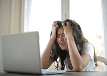 Frustrated worker using laptop