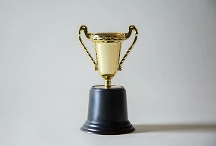 gold trophy grey background top 10 business transformation teams