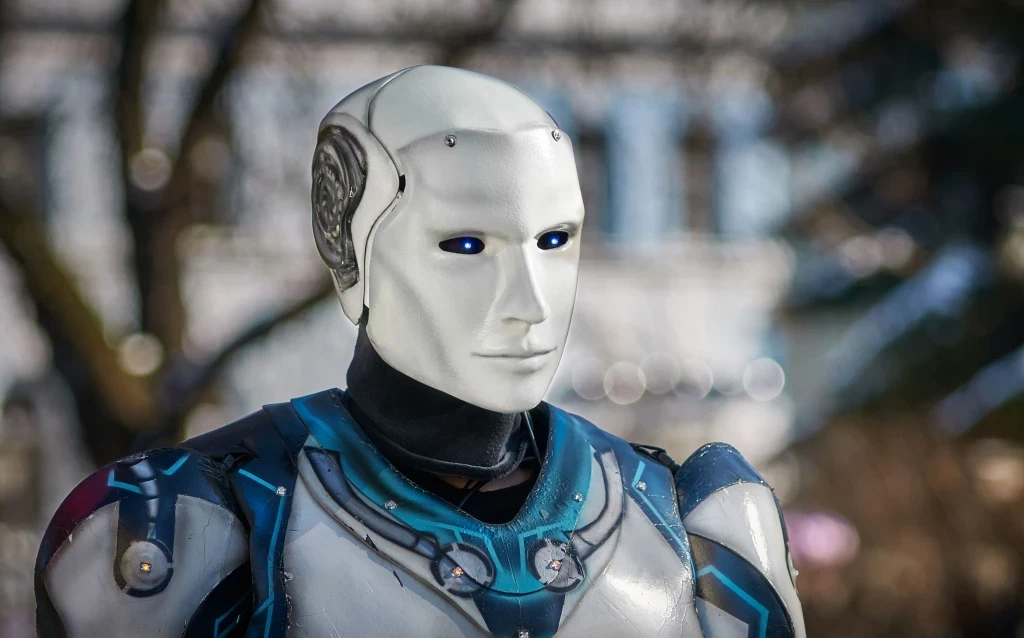 Close-up of a modern humanoid robot with glowing blue features on a green abstract background