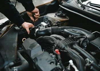 person fixing car engine