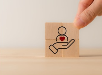 building blocks with hand and person outline and heart