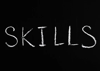 Businesses need more AI, OPEX & digital skills Skills written on blackboard