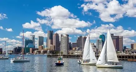 Boat tour in Boston Harbor at sunset