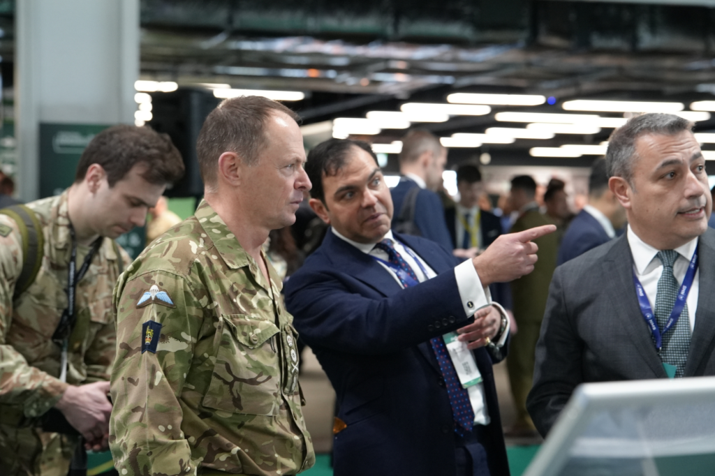 Military and industry attendees discussing capability at IAV
